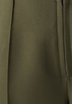 Olive green textile featuring a smooth, textured surface with a visible zipper and stitching detail along the seam for secure fastening.