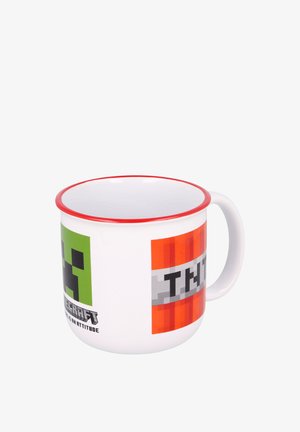 Ceramic mug, white with red rim, featuring green and orange block designs and black text reading "TNT" on a gray stripe. Smooth surface.