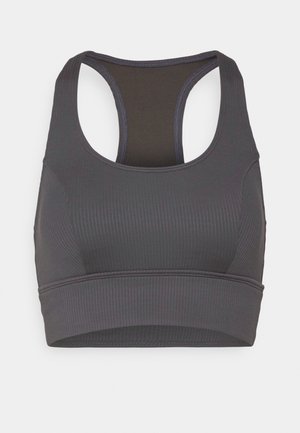 Soutien-gorge de sport gris foncé avec texture côtelée, bretelles larges et dos nageur. Dispose d'une bande sous poitrine sans couture et d'une doublure intérieure lisse.