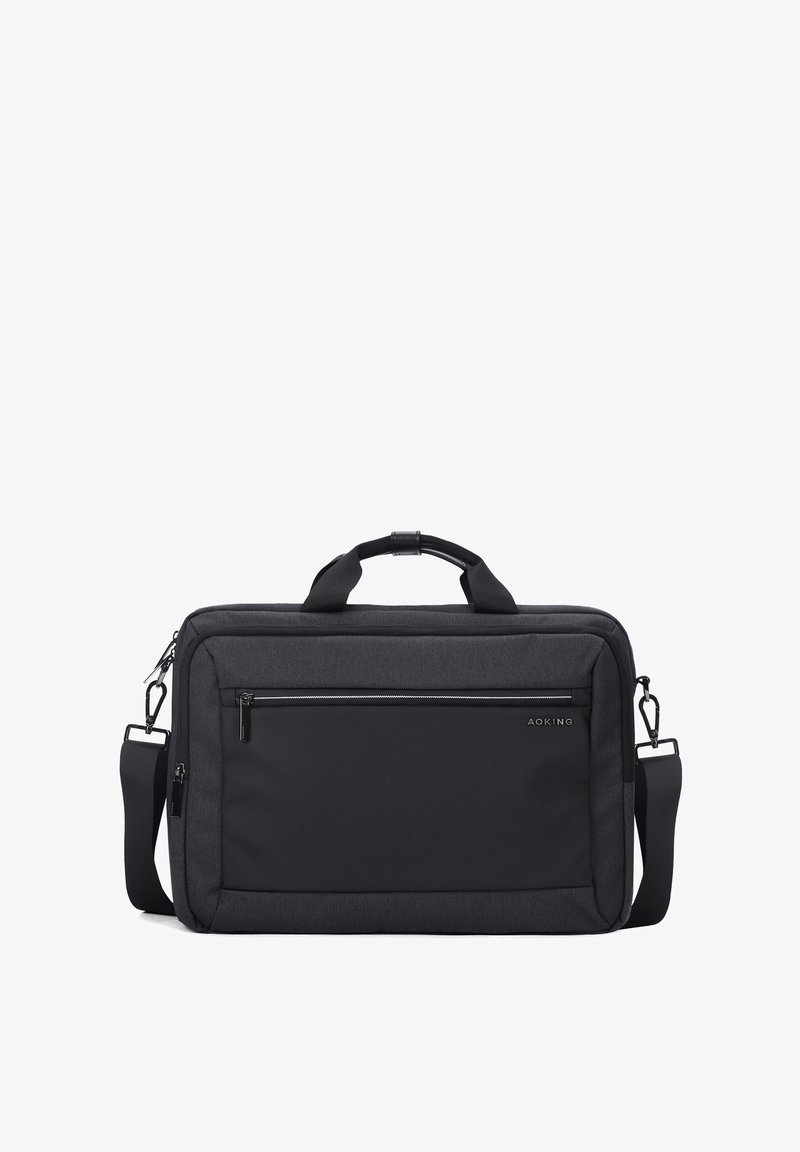 Sac à ordinateur en tissu noir avec une finition texturée, comprenant une poche zippée à l'avant, des poignées doubles et une bandoulière réglable. Design simple et moderne.