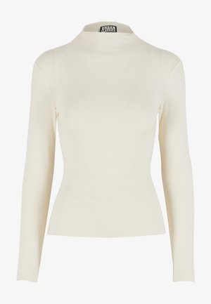 Top de manga larga color crema con diseño ajustado, cuello alto y material elástico. Presenta una textura suave y detalles mínimos en las costuras.