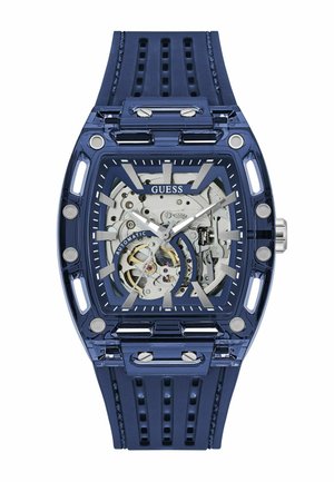 Orologio da polso Blue Guess con quadrante trasparente che mostra il movimento meccanico automatico, lancette e indicatori argentati, e cinturino in silicone blu traforato.