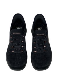Black Skechers shoes with a textured upper, featuring a lace-up design and subtle pink accents. Round toe and cushioned sole for comfort.