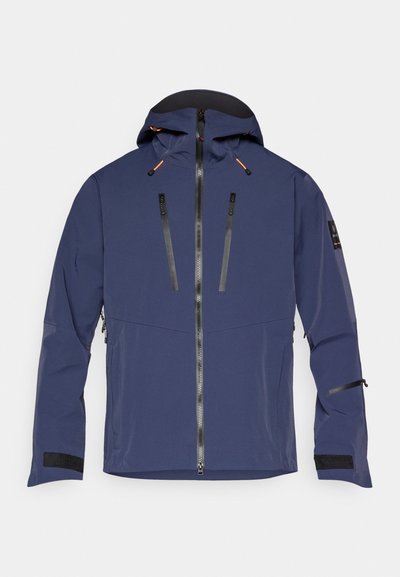Marineblaue Jacke mit Kapuze, Frontreißverschluss, zwei Reißverschlusstaschen auf der Brust und Klettverschlüssen an den Ärmelenden. Hergestellt aus einem glatten, wetterbeständigen Material.