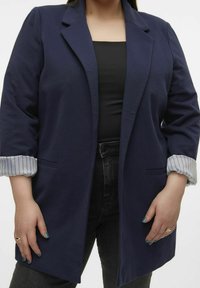 Marineblazer mit tailliertem Design, langen Ärmeln und gestreiften Manschetten. Verfügt über zwei Vorderaschen und eine glatte, weiche Textur.