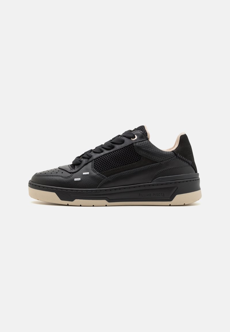 Black sneaker with textured leather and mesh panels, featuring a flat beige sole, round toe, and contrasting lace detailing.