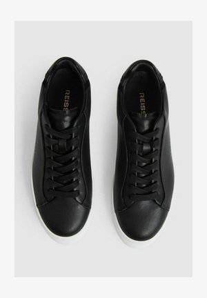 Black leather sneakers with a smooth texture, featuring a classic lace-up design, rounded toe, and white rubber sole. Gold brand logo inside.