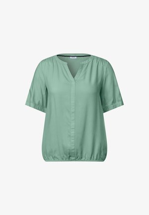 Mátově zelená blůza s krátkým rukávem a výstřihem do V, s nařaseným spodním lemem. Vyrobena z hladkého materiálu, má volný střih a minimální ševové detaily.