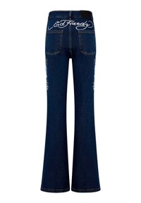 Blue denim flared jeans with embroidered details on pockets, featuring a visible "Ed Hardy" logo at the back. Smooth texture and classic cut.