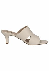 Mule-beige cu toc, cu partea superioară din imitație de piele netedă, prezentând un design cu curea încrucișată și un toc subțire și curbat. Talpă plată.