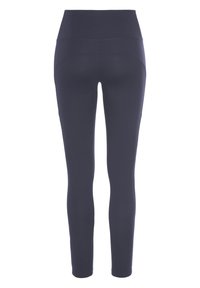 Leggings blu navy con vita alta, texture liscia, design aderente e senza cuciture visibili sul retro.