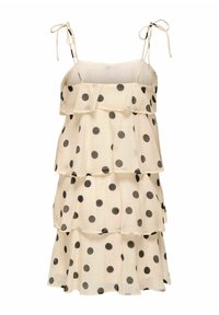 Robe crème avec volants superposés, pois noirs, fines bretelles nouées en nœuds et couches à volants.