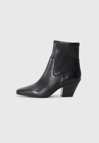 Black leather ankle boot with a pointed toe and a textured upper. Features a geometric block heel and elasticized collar for easy wear.