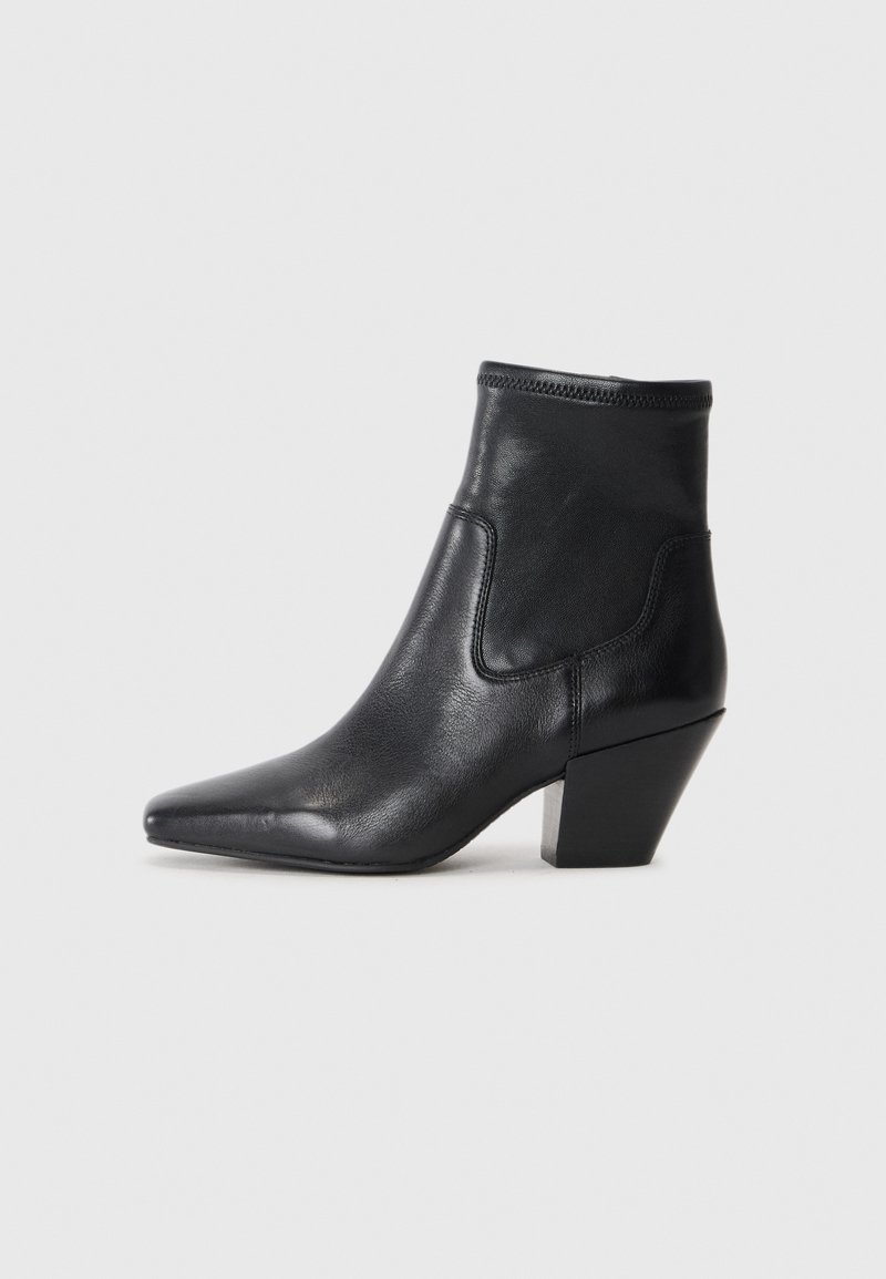 Black leather ankle boot with a pointed toe and a textured upper. Features a geometric block heel and elasticized collar for easy wear.
