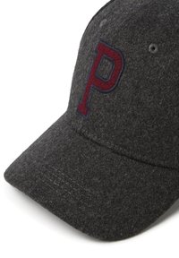 Gorra gris de lana con visera curva, que presenta un logotipo bordado en color marrón "P" en la parte frontal. Material texturizado con costuras visibles.