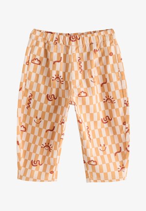 Elastische broeken voor kinderen met een ruitpatroon in perzik en crème, met lachende zonnen, wolken en kronkelige lijnen in roodbruin.