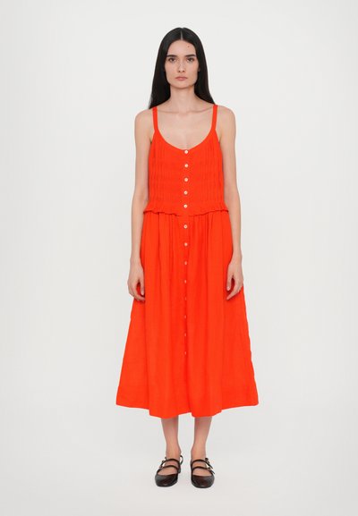 Robe midi rouge sans manches avec corsage froncé, devant à boutons et jupe évasée. Texture lisse ; détails minimaux.