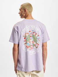 Lilac cotton T-shirt featuring a floral graphic design on the back, with text reading "SUMMER OF LOVE" and "peace comes with love."