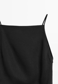 Black sleeveless dress with thin double spaghetti straps and a side zipper on a white background.