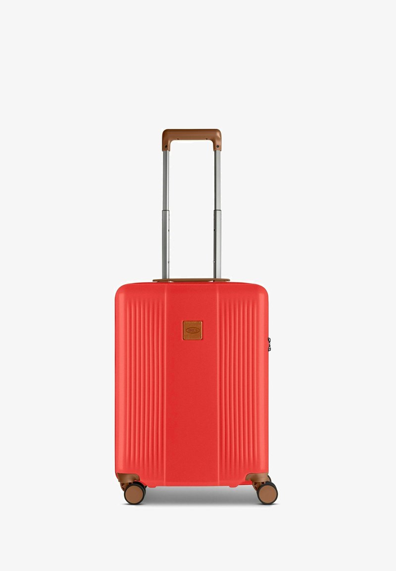 Red hard-shell suitcase with vertical ridges, brown top handle, and retractable metal handle; features four rolling wheels for mobility.