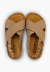 Beige leather sandals with crossed straps, adjustable metal buckle, and textured brown insoles. Simple design, open toe and heel.