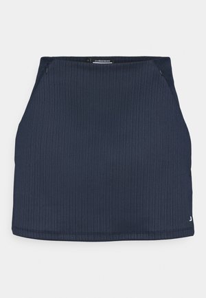 Námořnická modrá sukně s ribbovanou texturou, která má přiléhavý střih, boční zip a diskrétní logo na spodním lemu.