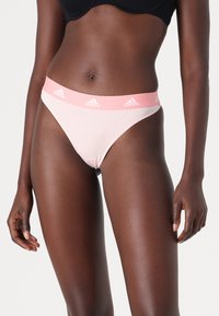 Lichtroze katoenen string met een brede roze Adidas-logo tailleband, met een soepele textuur en een ontwerp met minimale bedekking.