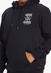 Black hooded sweatshirt with a front pocket. Features printed graphic logo on the chest in white. Made from soft, textured fabric.