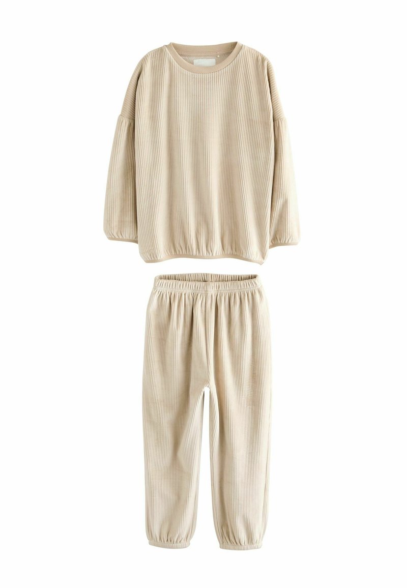 Beige ribbed lounge set, featuring a long-sleeve top with elastic hem and matching pants with elastic waistband and cuffs. Soft texture.