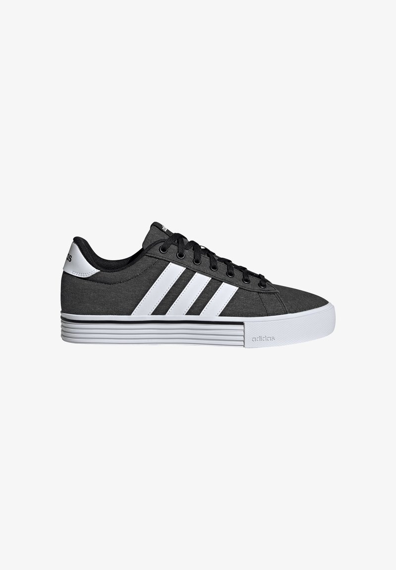 Black and white Adidas sneaker with three white stripes, black laces, padded collar, and thick white sole with textured design.