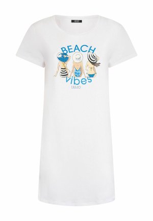 T-shirt blanc à manches courtes avec un graphique de trois figures en maillots de bain et le texte "BEACH vibes" en bleu. Matière en coton doux.