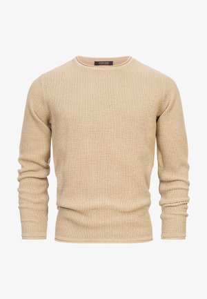Maglione beige lavorato a maglia con scollatura a girocollo, maniche lunghe e motivo a texture. Presenta un orlo e polsini a coste, realizzato in un materiale morbido.