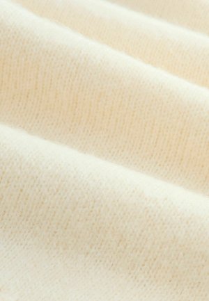 Texturovaná krémová tkanina s žebrovaným vzorem, která ukazuje měkké, jemné pletení a hladký, rovnoměrný povrch. Minimální variace v tónu.