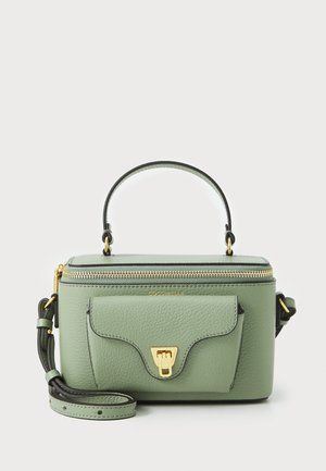 Green leather handbag with a top handle, gold hardware, and a detachable shoulder strap. Features a zip closure and front pocket.