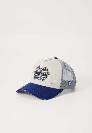Blue and gray trucker cap featuring a mesh back, curved brim, and embroidered logo with checkered accents. Distressed detailing on front.
