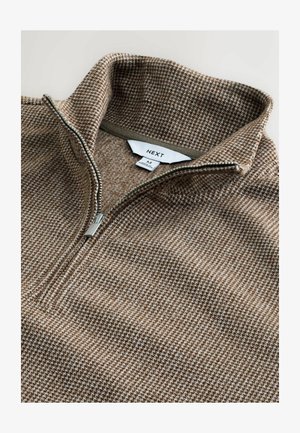 Brown zip-up sweater with a high collar, featuring a subtle houndstooth pattern and a silver zipper. Tag visible inside with brand name.