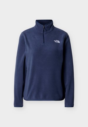 Marineblauer Fleece-Pullover mit hohem Kragen, halbem Reißverschluss vorne und weißem Markenlogo auf der linken Brust. Weiche Textur, lange Ärmel.