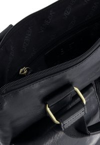 Černá kožená taška s viditelnou zlatou sponou a rozepnutou přihrádkou, která ukazuje na černou podšívku s nápisem "Venezia".