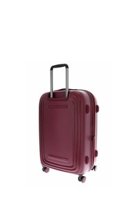 Valise rigide bourgogne avec poignée télescopique et quatre roues pivotantes, standing sur un fond blanc.