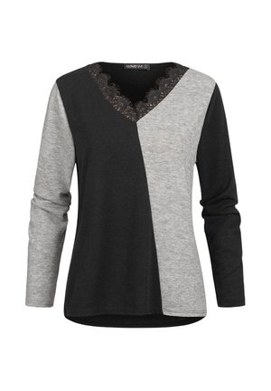 Haut femme à manches longues avec des blocs de couleur noir et gris asymétriques et col en V bordé de dentelle.