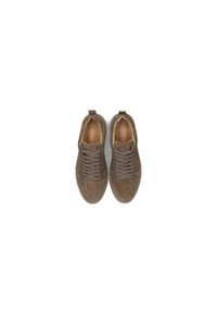 Brown suede sneakers with a round toe, textured exterior, and grey laces. Features a pull tab at the heel and contrasting interior lining.
