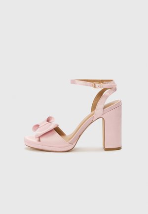 Pink satin high-heeled sandal with a rounded toe, wide strap featuring a bow detail, and an ankle strap with a gold buckle.