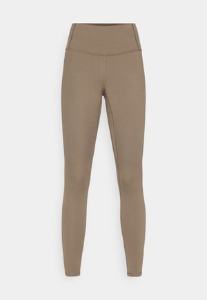Bruna leggings tillverkade av stretchigt tyg med hög midja och figursydd design, med släta sömmar och utan synliga mönster.