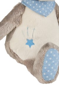 Plush toy with soft beige and white fur, blue star-patterned accents, and a blue embroidered star on the belly. A cozy, rounded shape.