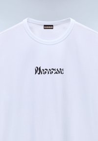 White cotton t-shirt featuring a black distorted text design that reads "Napapijri" on the chest, with a round neck and short sleeves.