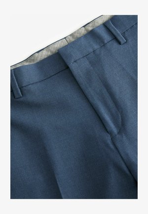 Pantalons tailleur bleu marine avec une texture lisse, présentant un devant plat et une doublure à motifs grise visible au niveau de la taille.