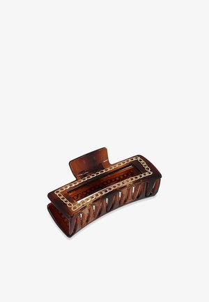 Pince à cheveux en plastique marron avec un design rectangulaire, présentant un motif découpé et un accent de chaîne dorée le long des bords.
