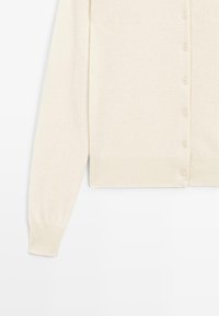 Beige knit cardigan with long sleeves, featuring a round neckline and a row of buttons down the front. Soft, textured fabric.