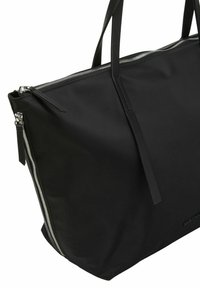 Black tote bag made of smooth material, featuring a top zipper closure, long shoulder straps, and minimalistic design with no visible patterns.
