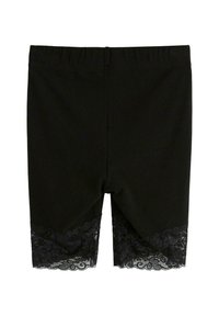 Sorte strækshorts med en blondekant i kanten. Shortsene har en elastisk talje og en glat, mat tekstur.